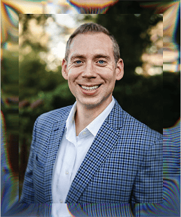 Business professional smiling outdoors, representing alignment and success.